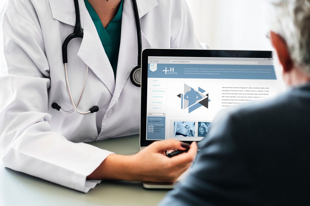 A senior medical professional using technology to explain test results