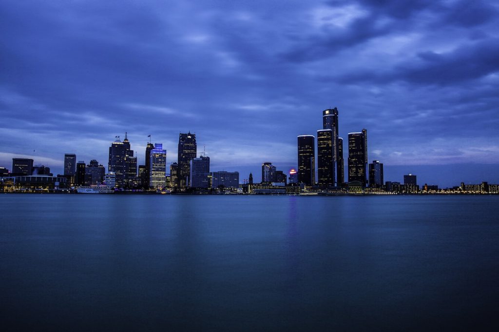 The Detroit city skyline at night from over the lake.
