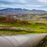 A long pipeline running through a mountainous countryside