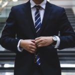 A senior technology executive in a navy blue suit