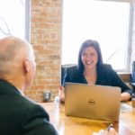 A technical executive candidtae sitting across a table from a recruiter.