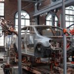 A new car being built in an automated factory with industry 4.0 and IoT device connectivity