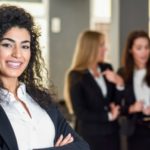 woman executive standing in front of staff in the background
